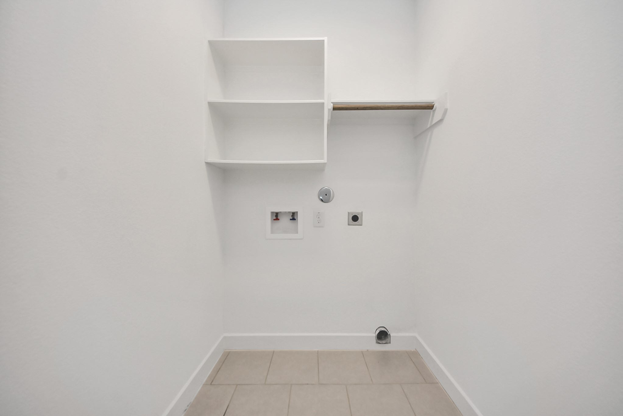 18716 Centro Main Street Conroe, TX 77385 - Photo 39 of 50 Dedicated laundry area with built-in shelving and washer/dryer connections, offering practical storage and convenience.