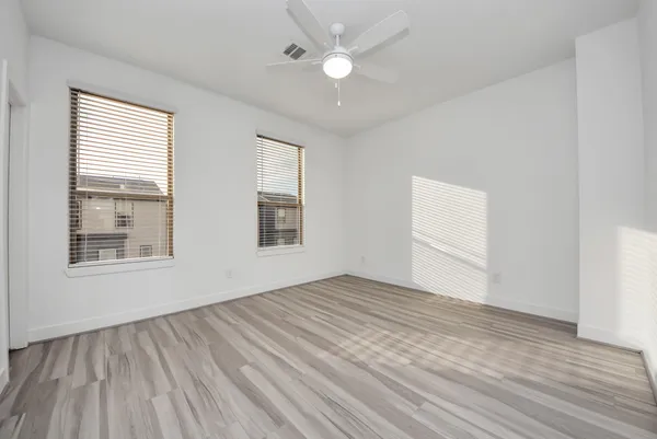 wooden floor in an empty room with a window