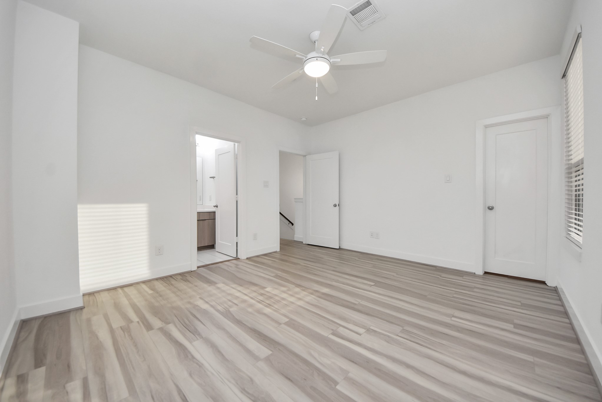 18716 Centro Main Street Conroe, TX 77385 - Photo 43 of 50 Alternate view of the secondary bedroom showcasing generous wall space, modern flooring, and abundant natural light.
