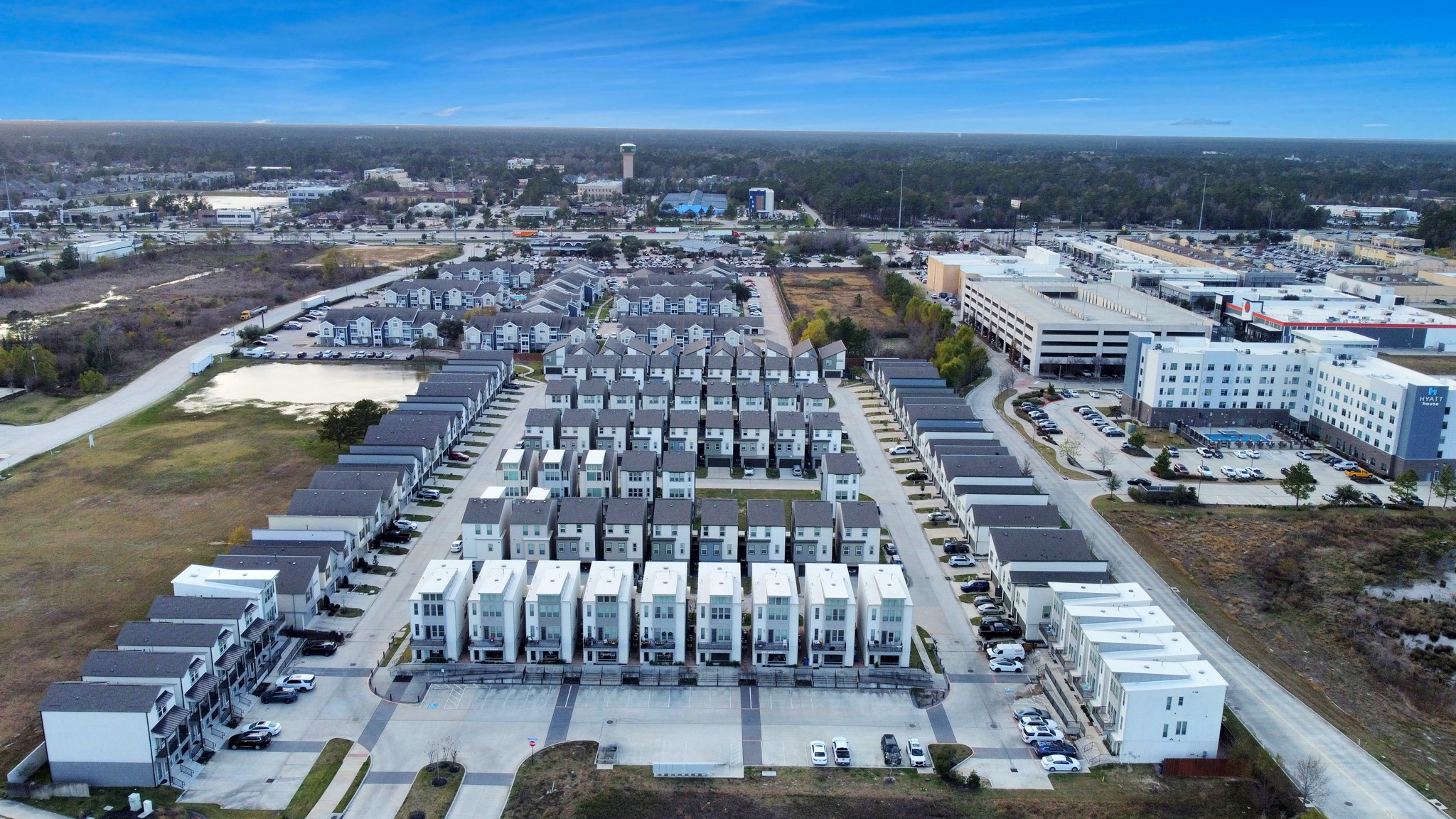 18716 Centro Main Street Conroe, TX 77385 - Photo 48 of 50 Aerial view highlighting the Centro development with dedicated live/work residences, surrounding green space, and proximity to shopping, dining, and major thoroughfares. Digitally Enhanced.