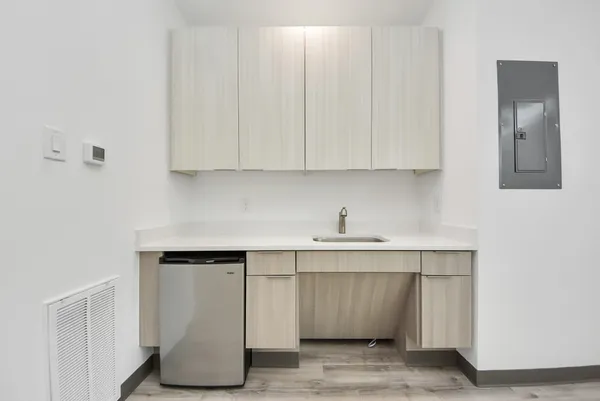 a view of a kitchen with a sink and a refrigerator