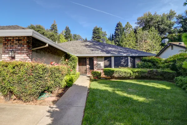 a view of a house with a yard and garden