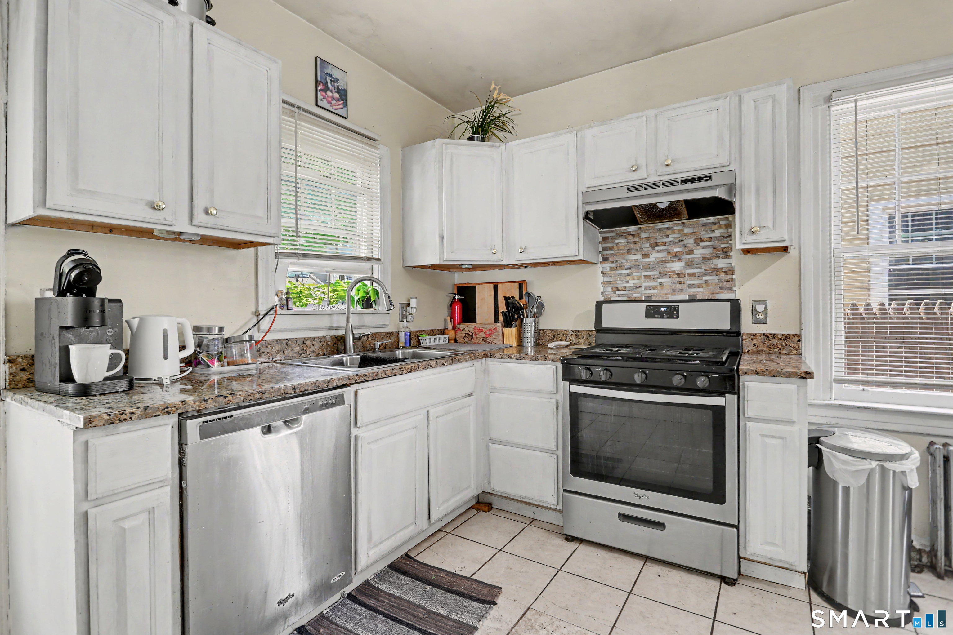 94 2nd Street Hamden, CT 06514 - Photo 14 of 31 a kitchen with stainless steel appliances granite countertop a sink a stove a microwave and cabinets