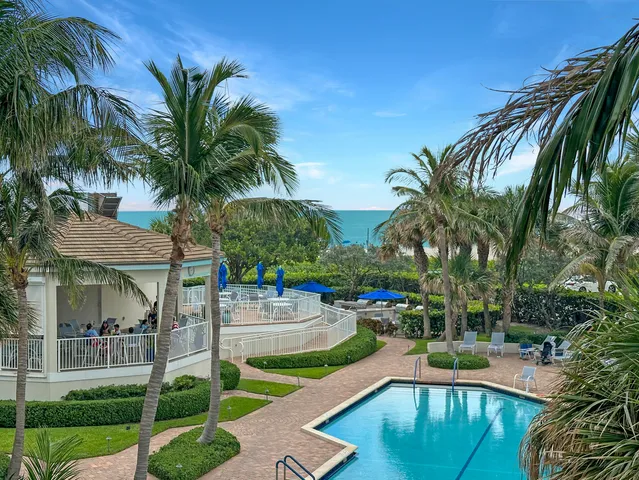 a swimming pool with outdoor seating and yard