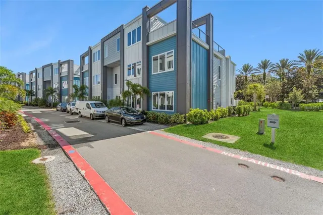 a multi story building with trees in front of it