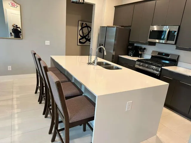 a kitchen with a table chairs and a refrigerator