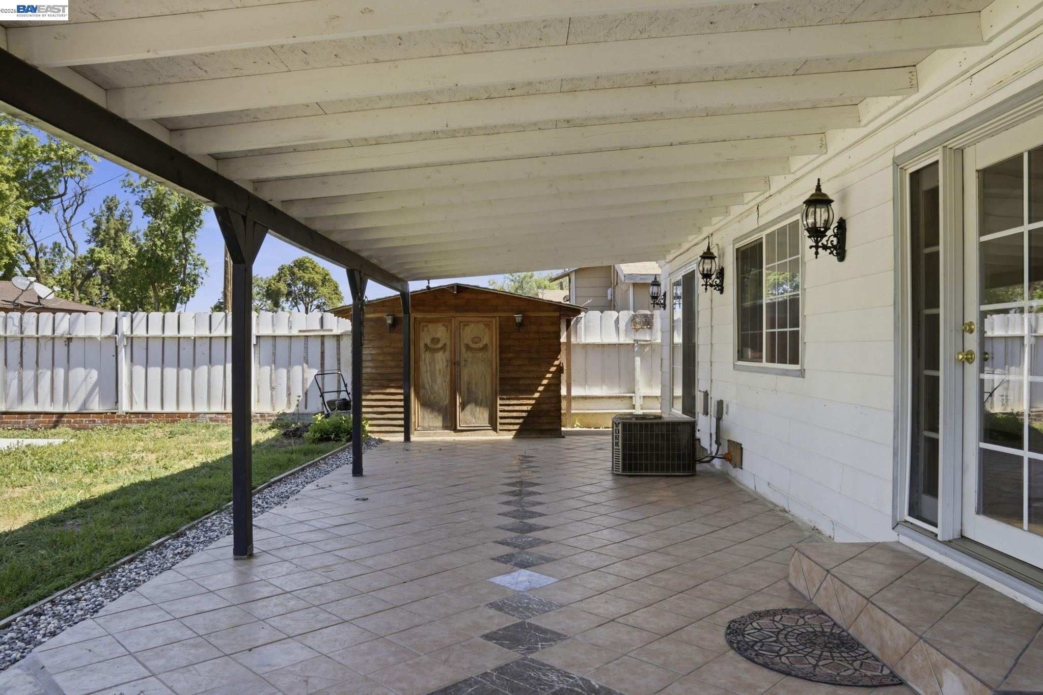 315 M Street Patterson, CA 95363 - Photo 14 of 17 a view of a porch with furniture and a yard