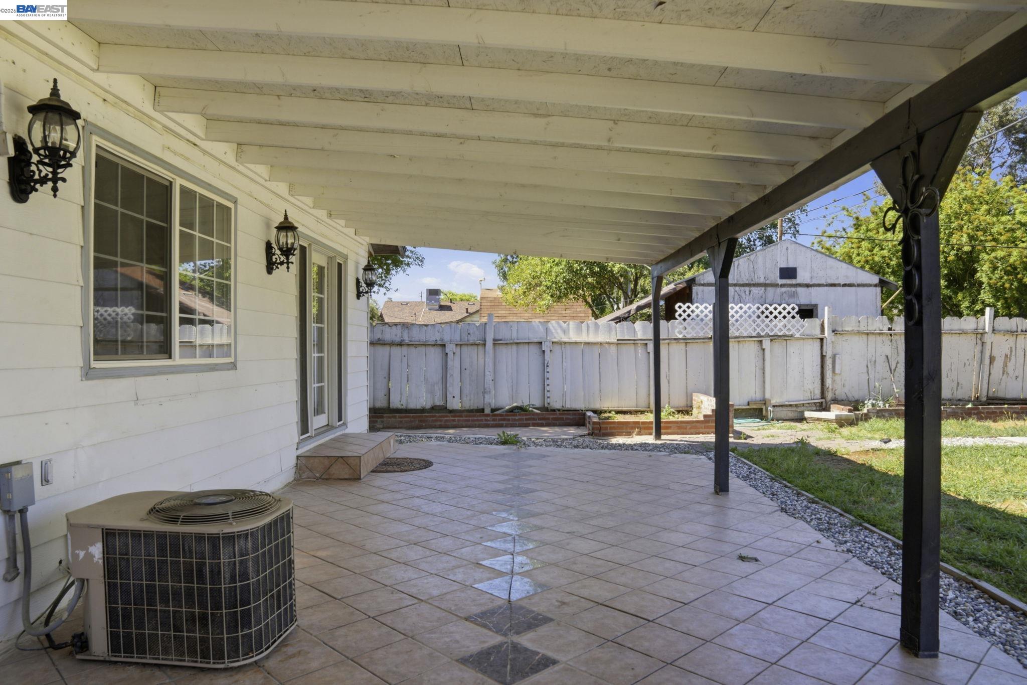 315 M Street Patterson, CA 95363 - Photo 15 of 17 a backyard of a house with barbeque oven table and chairs