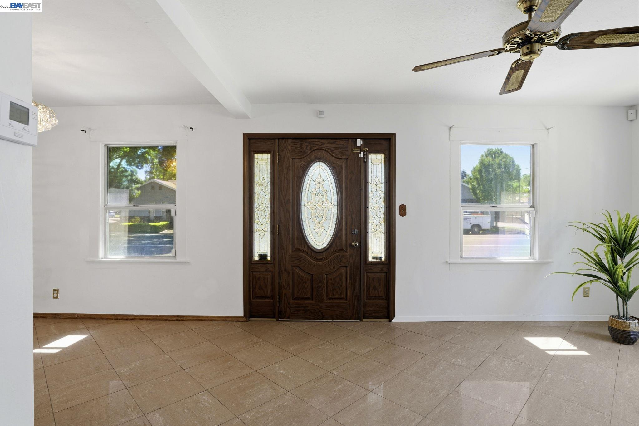 315 M Street Patterson, CA 95363 - Photo 3 of 17 an empty room with windows and outdoor view
