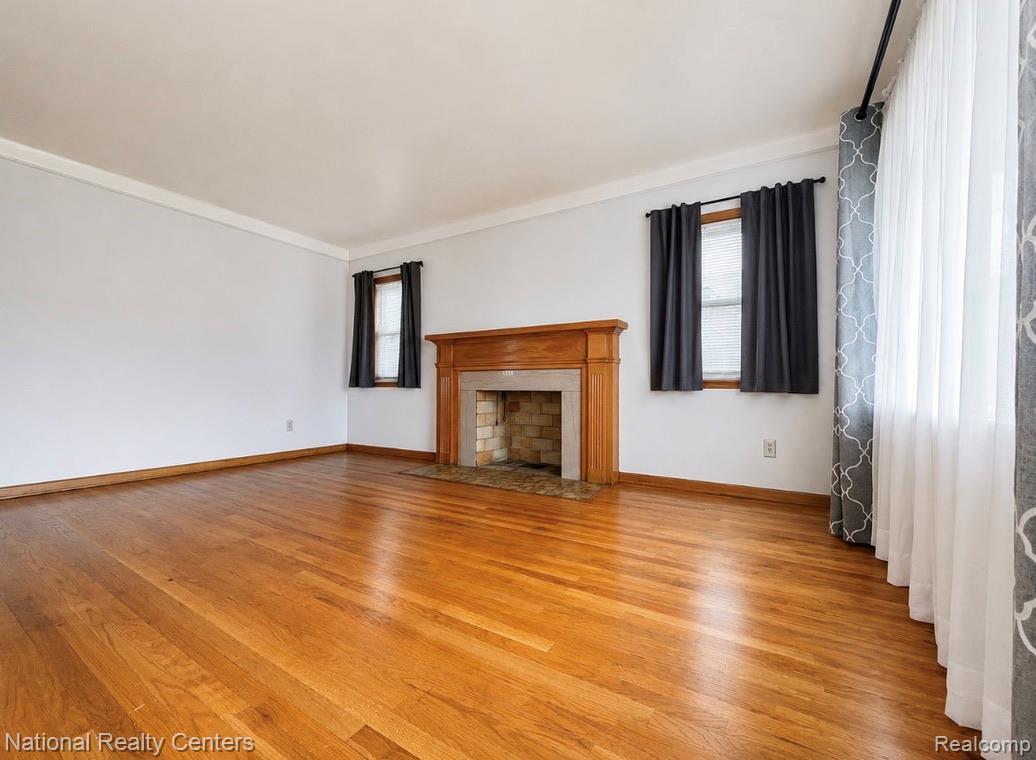 7285 Helen Street Center Line, MI 48015 - Photo 8 of 32 Spacious room featuring wood-finish flooring, a wood fireplace mantel, and white baseboards