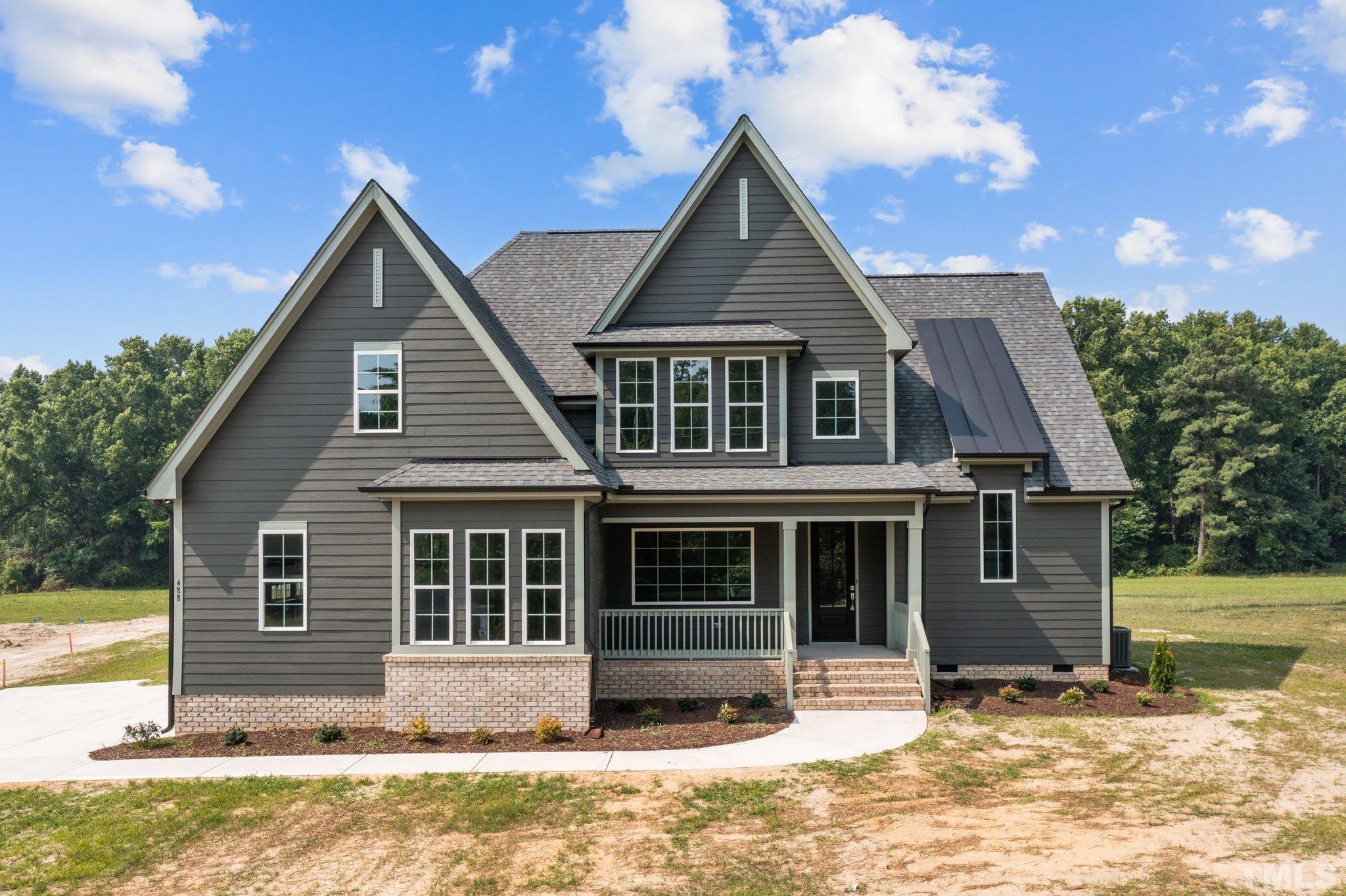 488 Pine Ridge Road Zebulon, NC 27597 - Photo 1 of 47 a front view of a house with a yard outdoor seating and yard