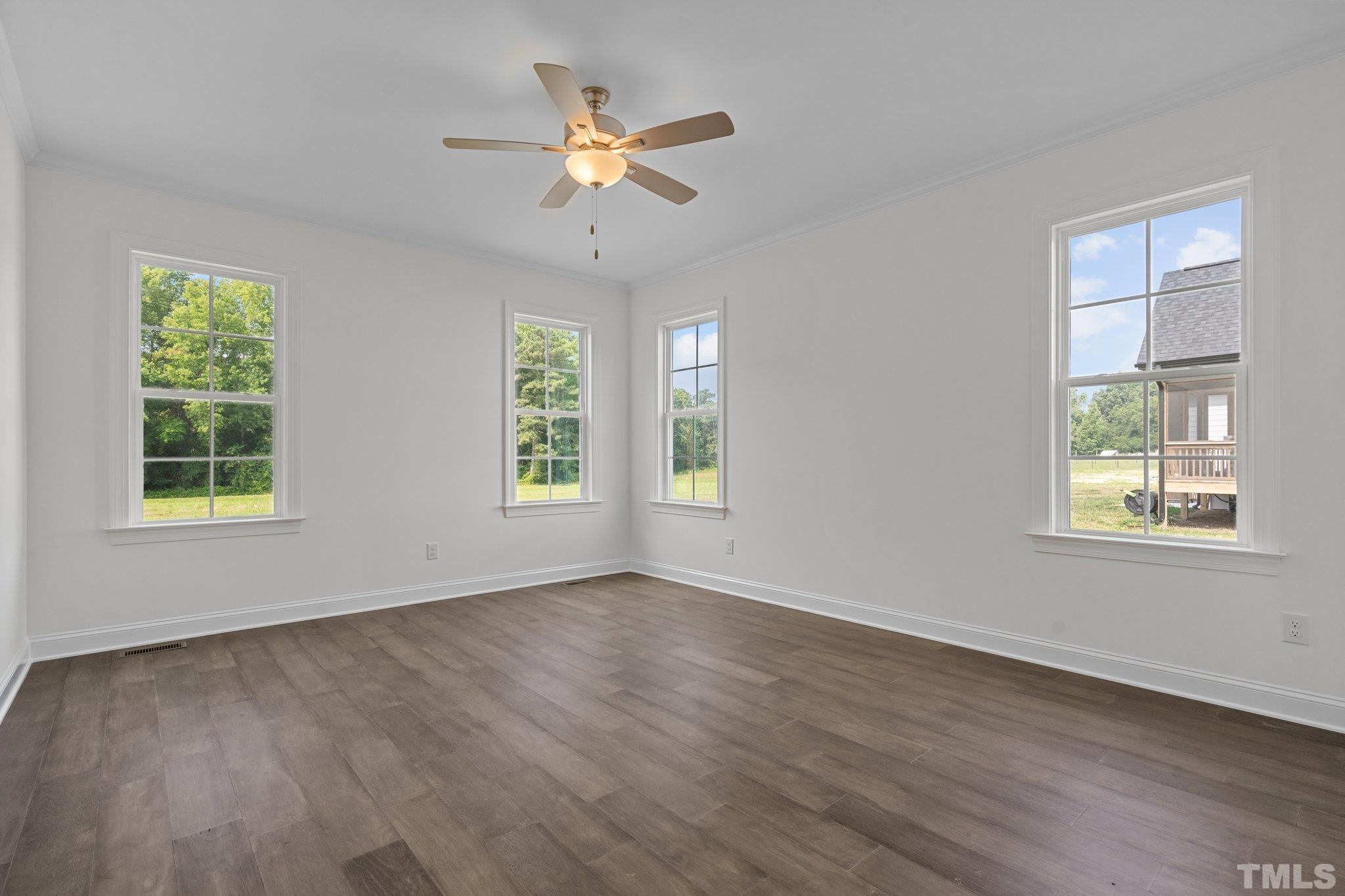 488 Pine Ridge Road Zebulon, NC 27597 - Photo 13 of 47 a view of an empty room with a window and wooden floor