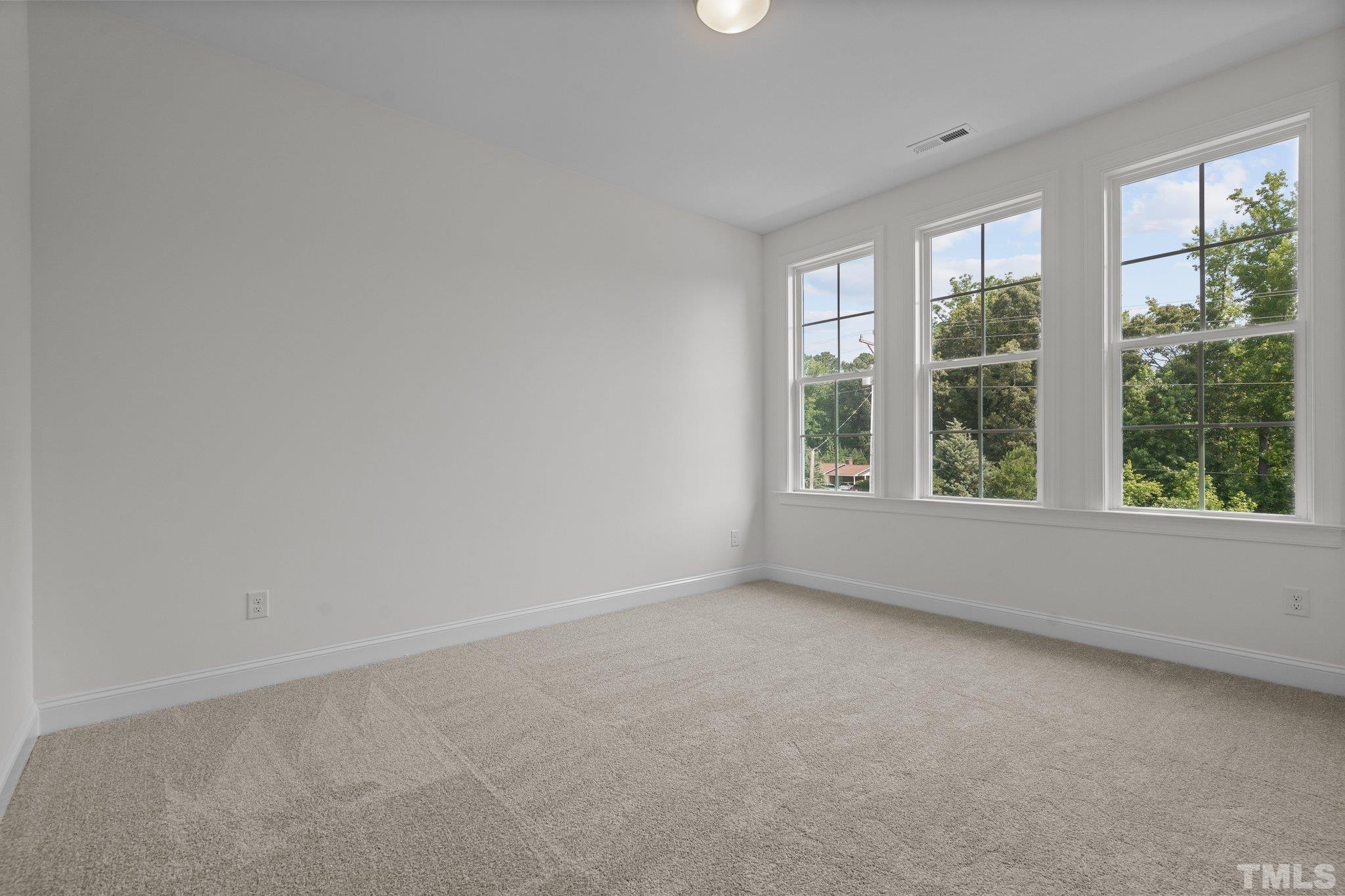 488 Pine Ridge Road Zebulon, NC 27597 - Photo 23 of 47 an empty room with windows
