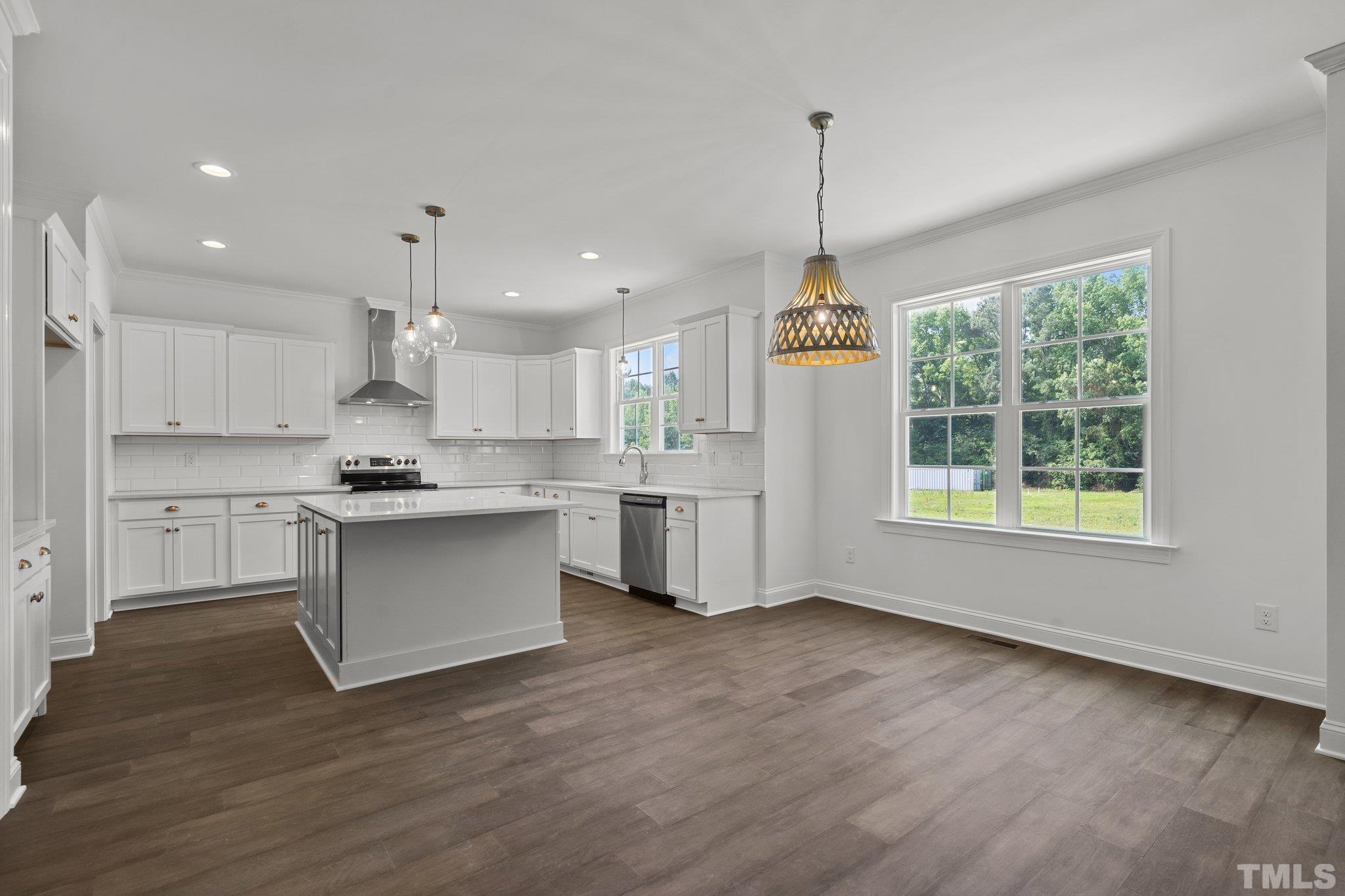 488 Pine Ridge Road Zebulon, NC 27597 - Photo 5 of 47 a kitchen with white cabinets and window