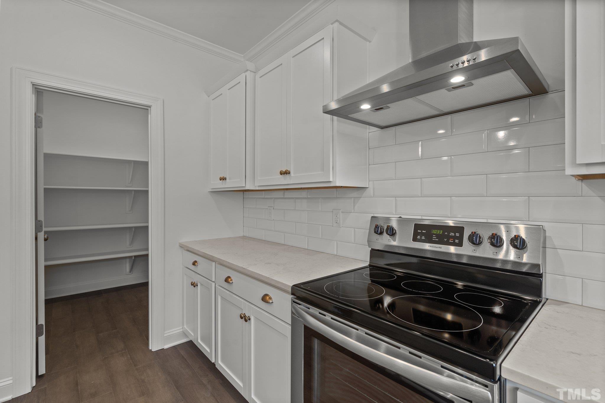 488 Pine Ridge Road Zebulon, NC 27597 - Photo 6 of 47 a kitchen with white cabinets and appliances