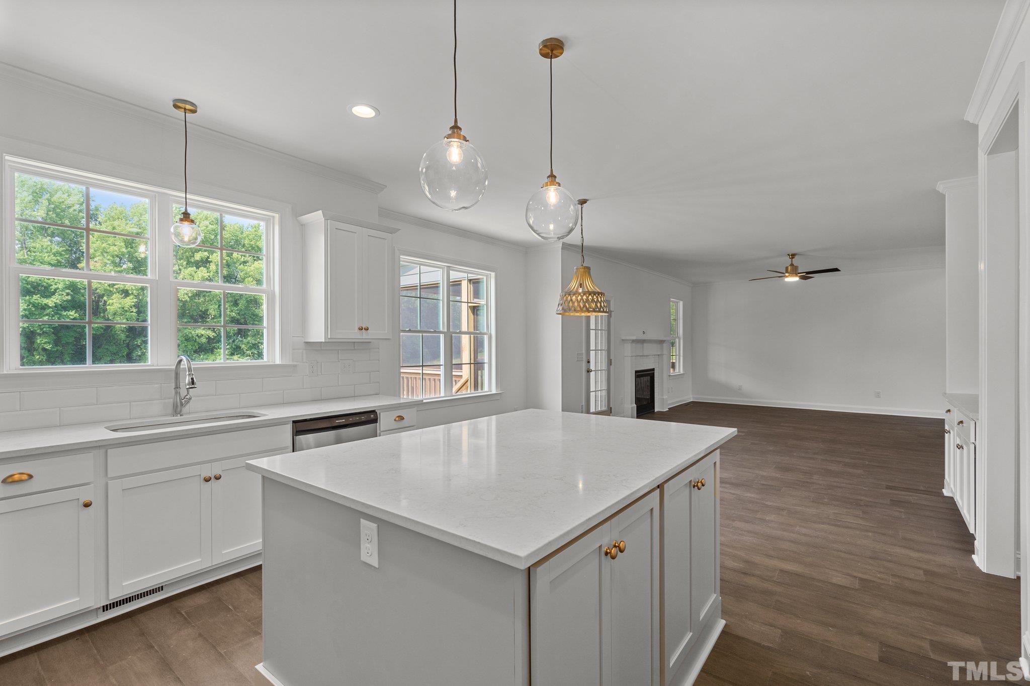 488 Pine Ridge Road Zebulon, NC 27597 - Photo 8 of 47 a kitchen with a stove center island and windows