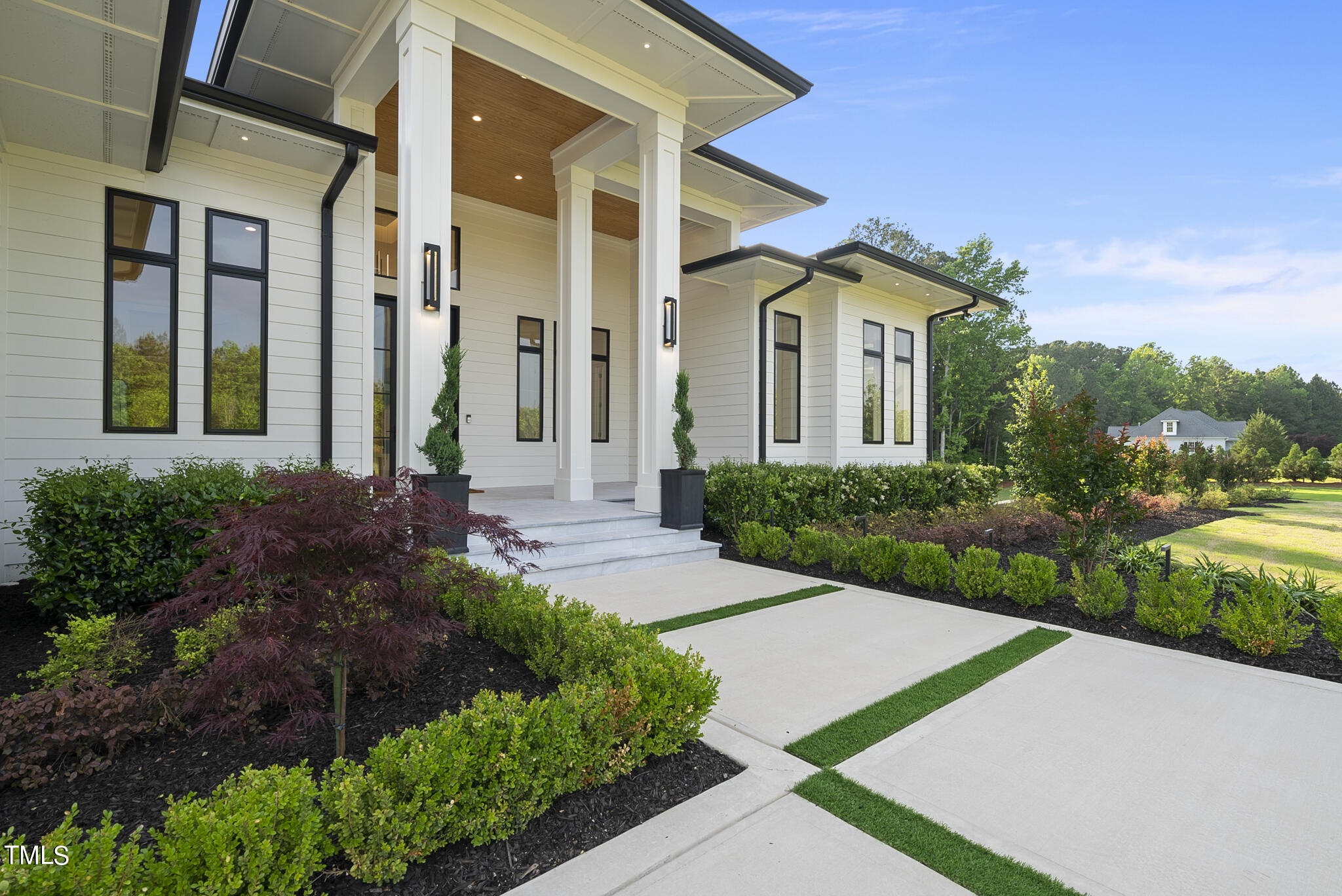 393 Barbee Road Apex, NC 27523 - Photo 2 of 3 a front view of a house with a garden