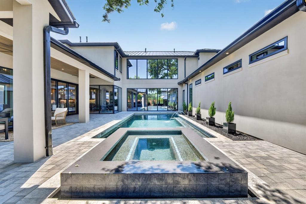 11028 Edgemere Road Dallas, TX 75230 - Photo 37 of 40 Expansive outdoor living area featuring a rectangular pool and integrated spa