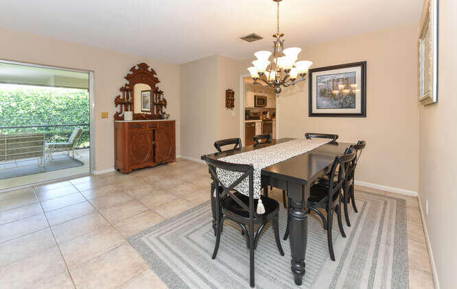 493 Forestview Drive Atlantis, FL 33462 - Photo 11 of 27 a view of a dining room with furniture window and wooden floor