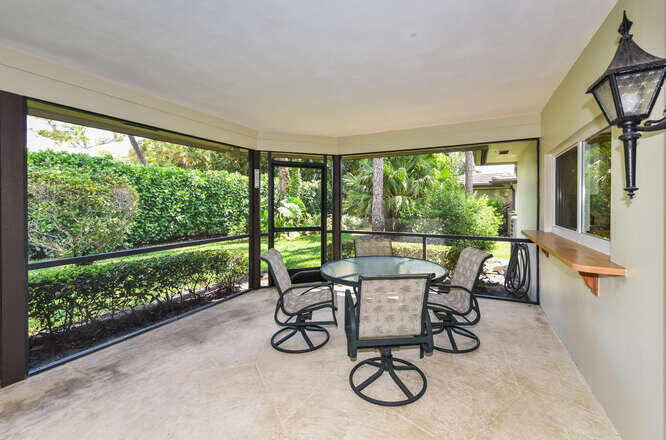 493 Forestview Drive Atlantis, FL 33462 - Photo 17 of 27 a view of a porch with furniture and garden