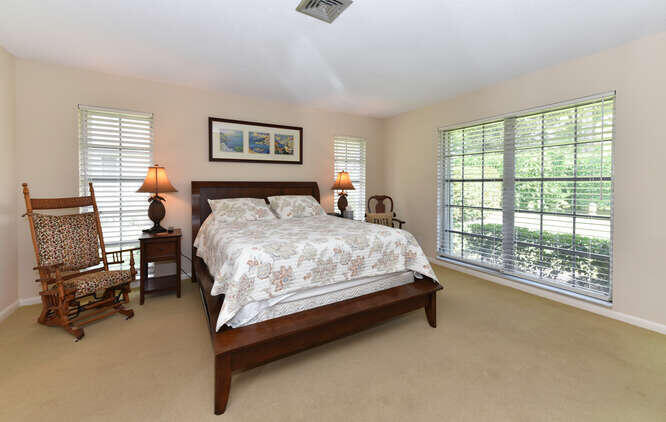 493 Forestview Drive Atlantis, FL 33462 - Photo 20 of 27 a bedroom with a bed chair and window