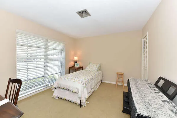a bedroom with double bed and a window