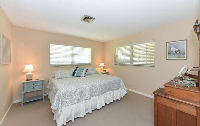 493 Forestview Drive Atlantis, FL 33462 - Photo 24 of 27 a bedroom with double bed and a window