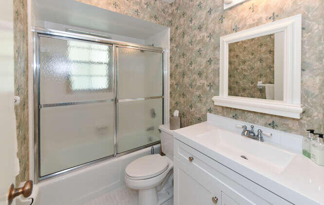 493 Forestview Drive Atlantis, FL 33462 - Photo 25 of 27 a bathroom with a sink toilet and shower
