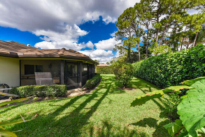 493 Forestview Drive Atlantis, FL 33462 - Photo 4 of 27 a view of a house with a flower garden