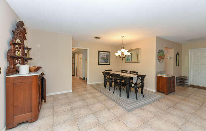 493 Forestview Drive Atlantis, FL 33462 - Photo 7 of 27 a view of a dining room with furniture and chandelier