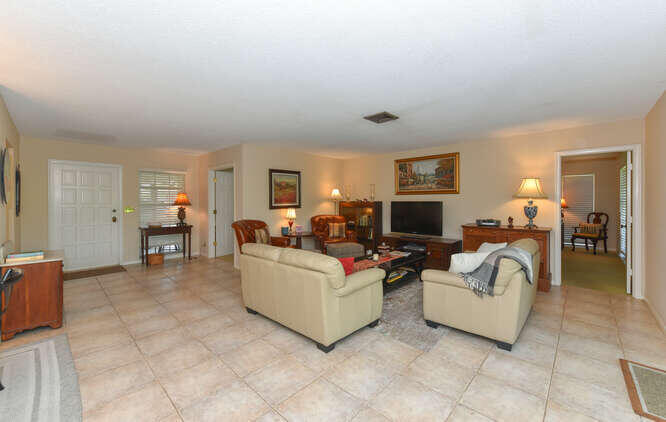 493 Forestview Drive Atlantis, FL 33462 - Photo 9 of 27 a living room with furniture and a flat screen tv