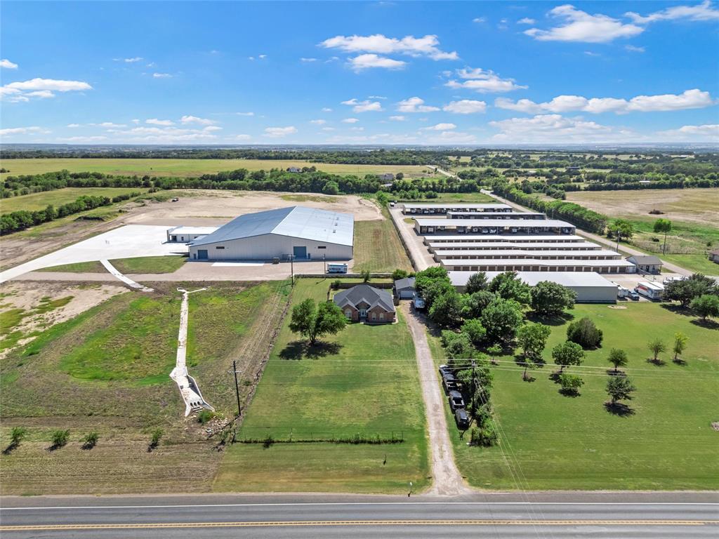 3696 Old Lorena Road Lorena, TX 76655 - Photo 26 of 27 Expansive property featuring multiple structures including a large warehouse, extensive storage units, and a brick-built residential structure