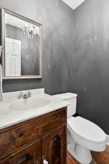 a bathroom with a sink a toilet and mirror