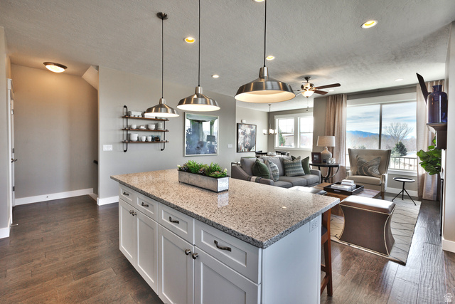 252 East Sandy Sage Way Sandy, UT 84070 - Photo 11 of 36 Kitchen island with a light-toned granite countertop and white cabinetry