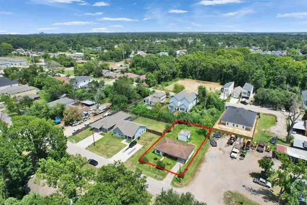 an aerial view of multiple houses with yard