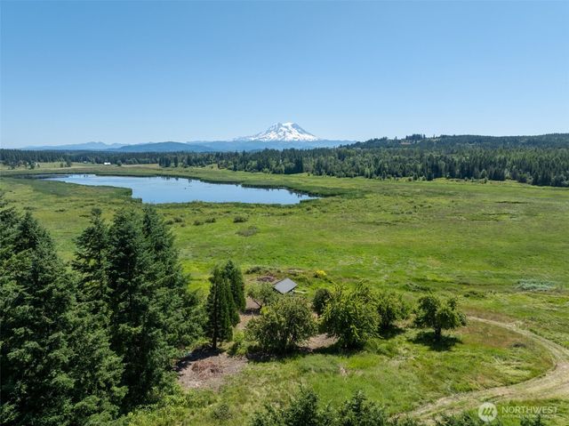 a view of a lake with houses in the back