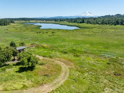 a view of a lake with a house in the background