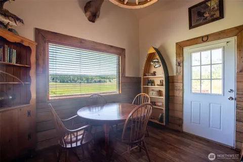 a view of a dining room with furniture window and wooden floor