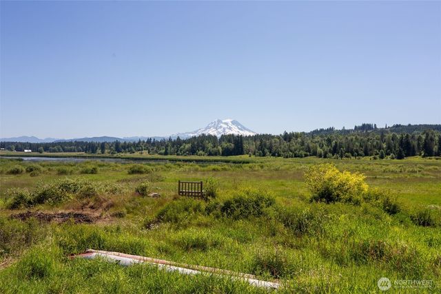 a view of a lake with houses in the back