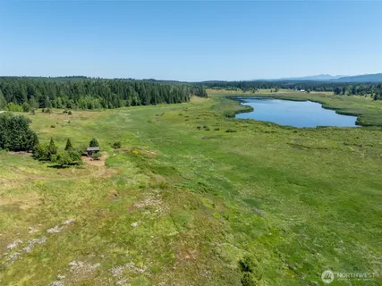 a view of a lake with houses in the back