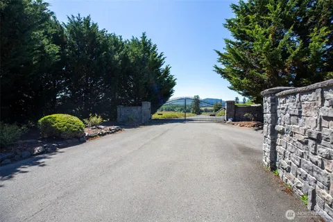 a view of a street with a bench and trees