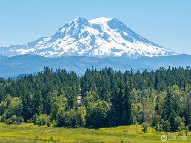 a view of a golf course with the ocean