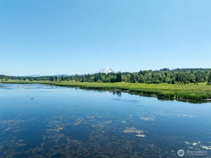 a view of a lake with houses in the back