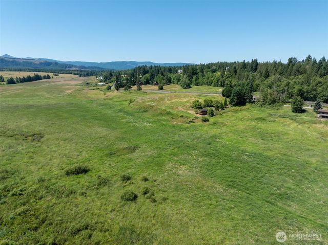 a view of a lake with houses in the back