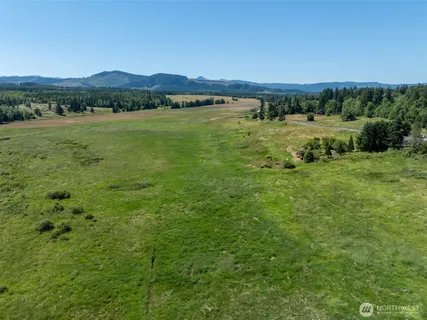 a view of a lake with houses in the back