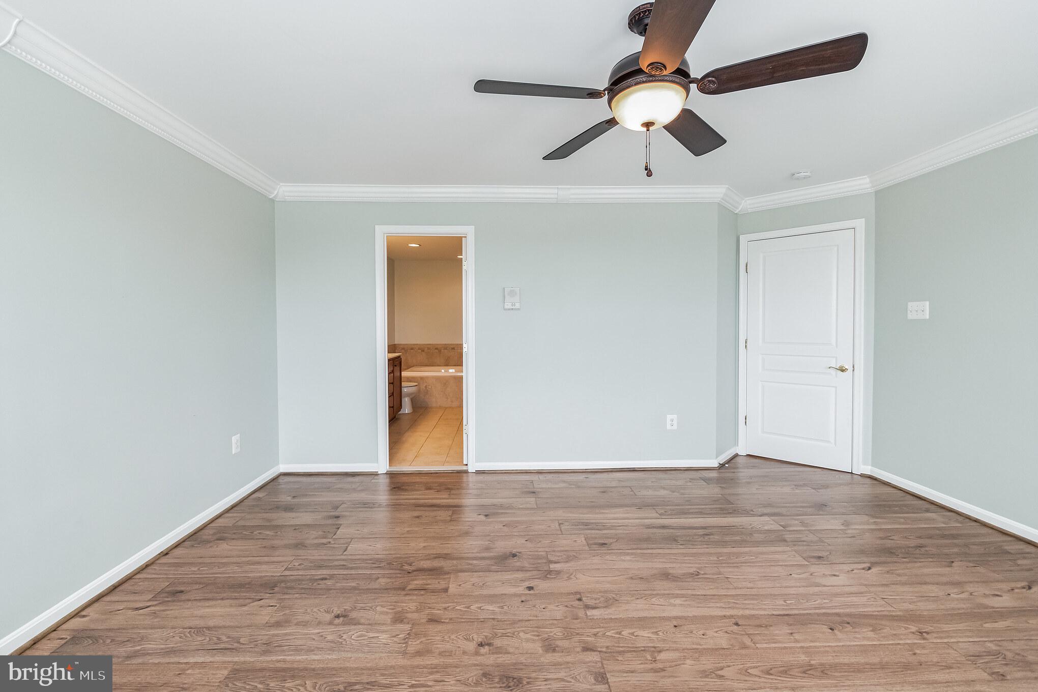 1834 Monocacy View Circle, Unit 53B Frederick, MD 21701 - Photo 14 of 30 a view of an empty room with window and wooden floor