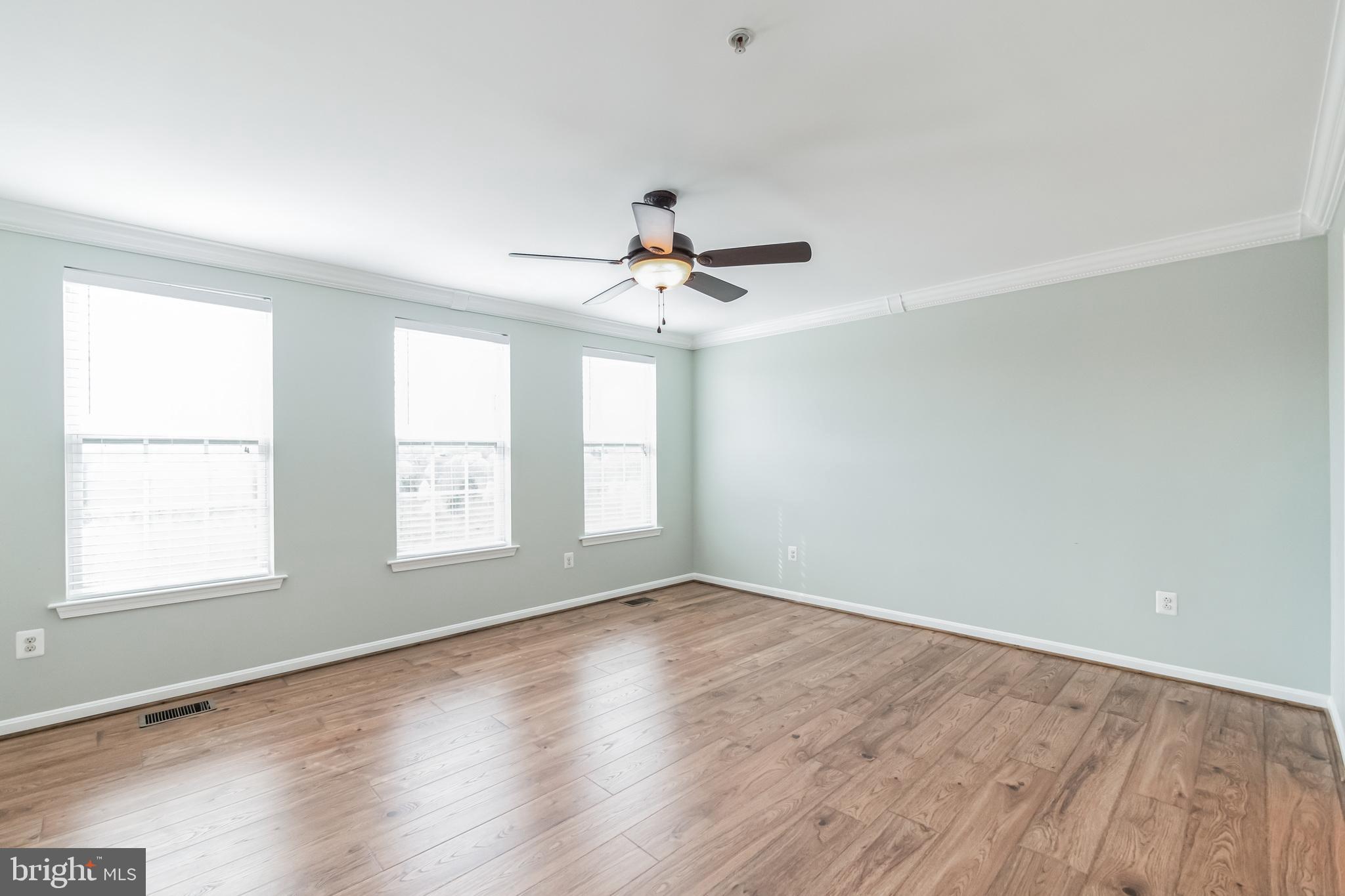 1834 Monocacy View Circle, Unit 53B Frederick, MD 21701 - Photo 15 of 30 an empty room with wooden floor and windows
