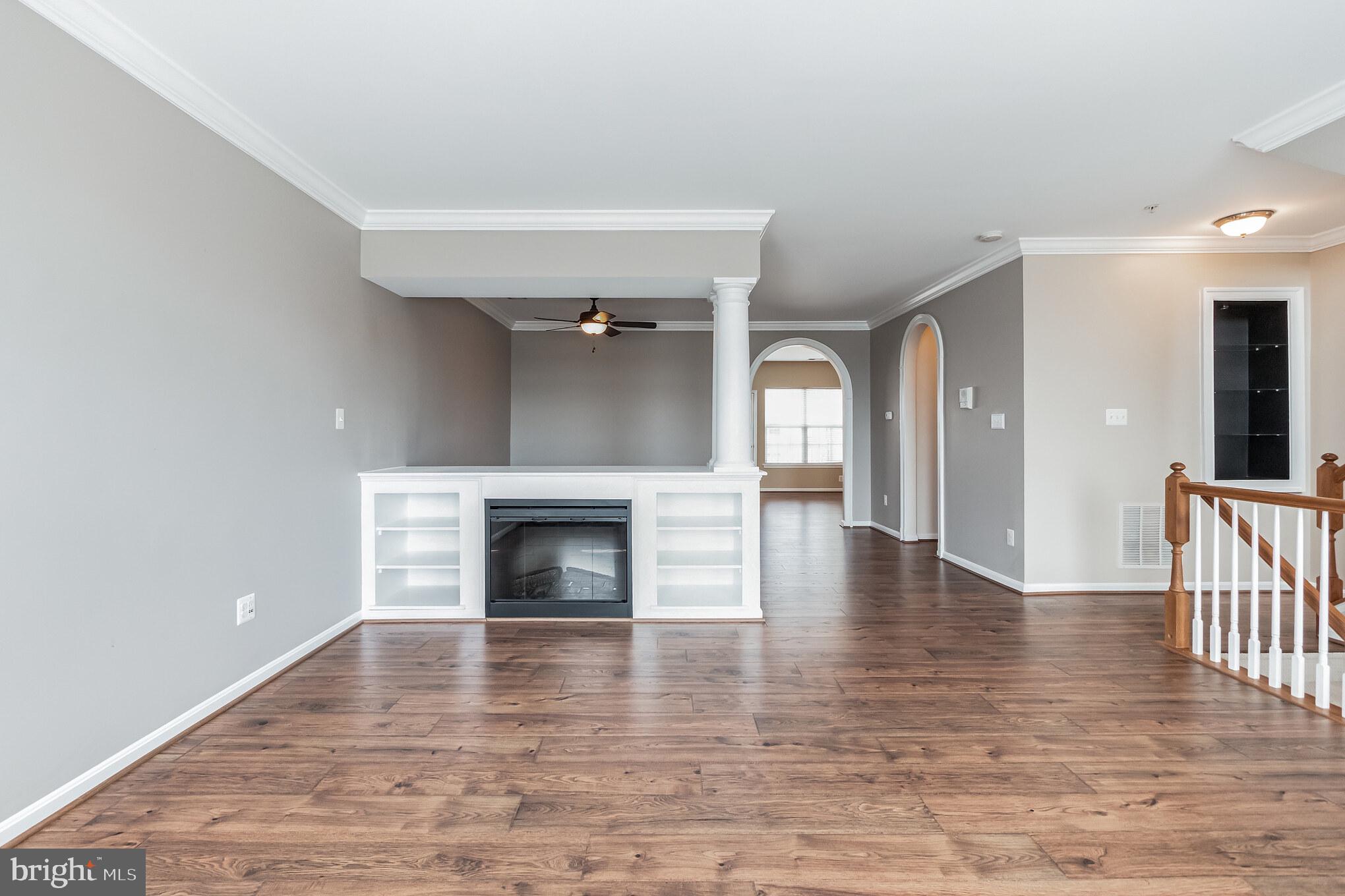 1834 Monocacy View Circle, Unit 53B Frederick, MD 21701 - Photo 2 of 30 a view of an empty room with wooden floor fireplace and a window
