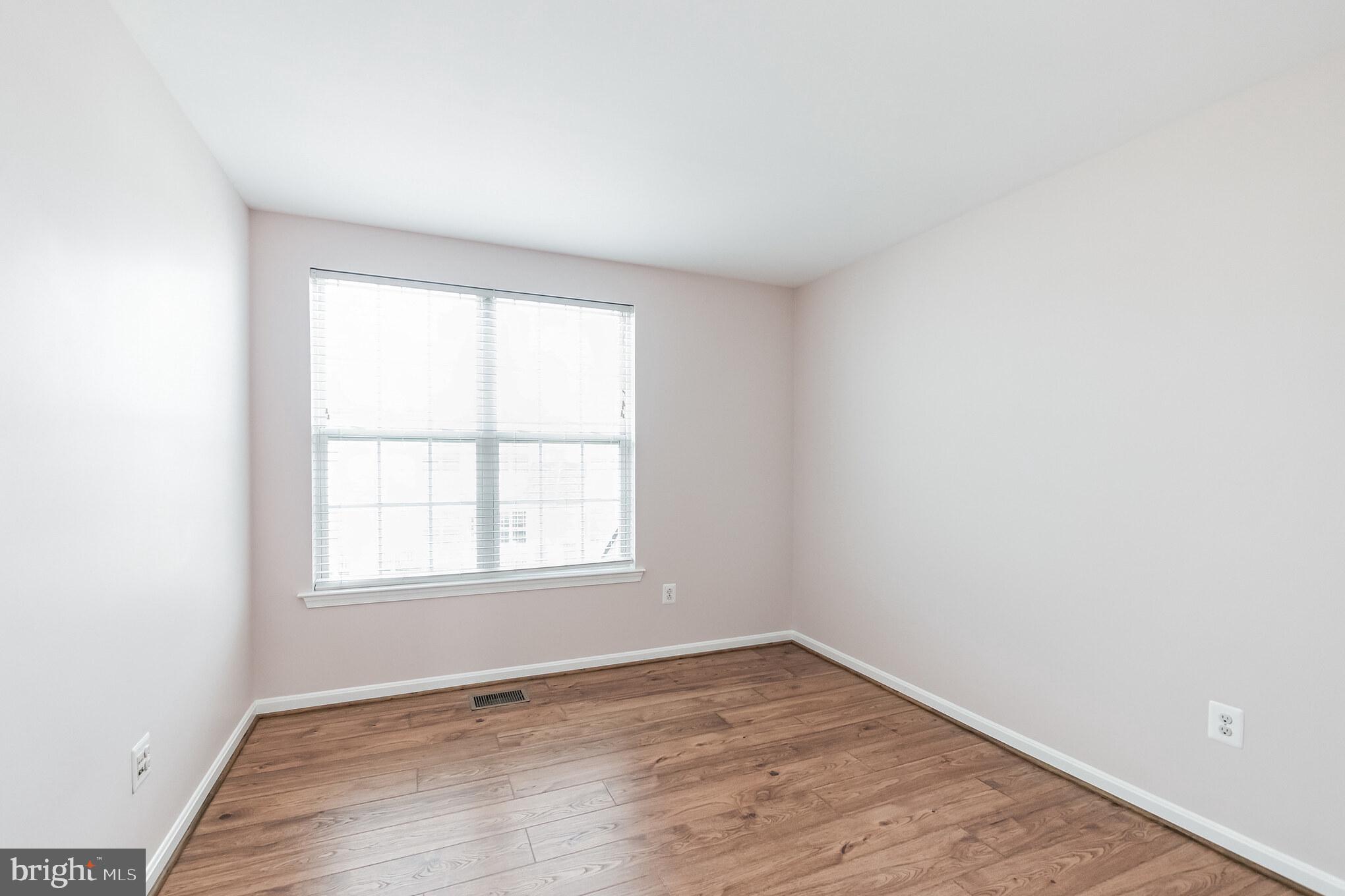 1834 Monocacy View Circle, Unit 53B Frederick, MD 21701 - Photo 22 of 30 an empty room with wooden floor and window