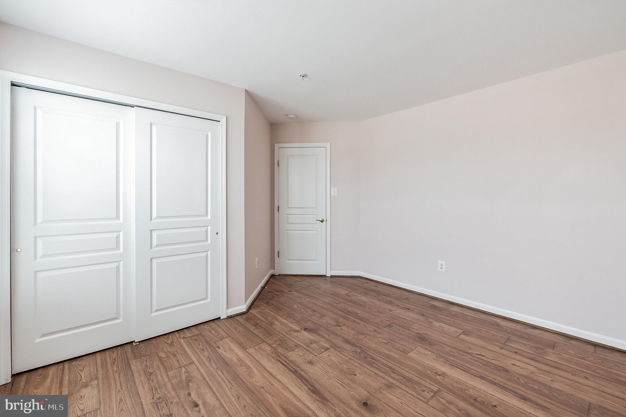 1834 Monocacy View Circle, Unit 53B Frederick, MD 21701 - Photo 25 of 30 a view of an empty room with wooden floor